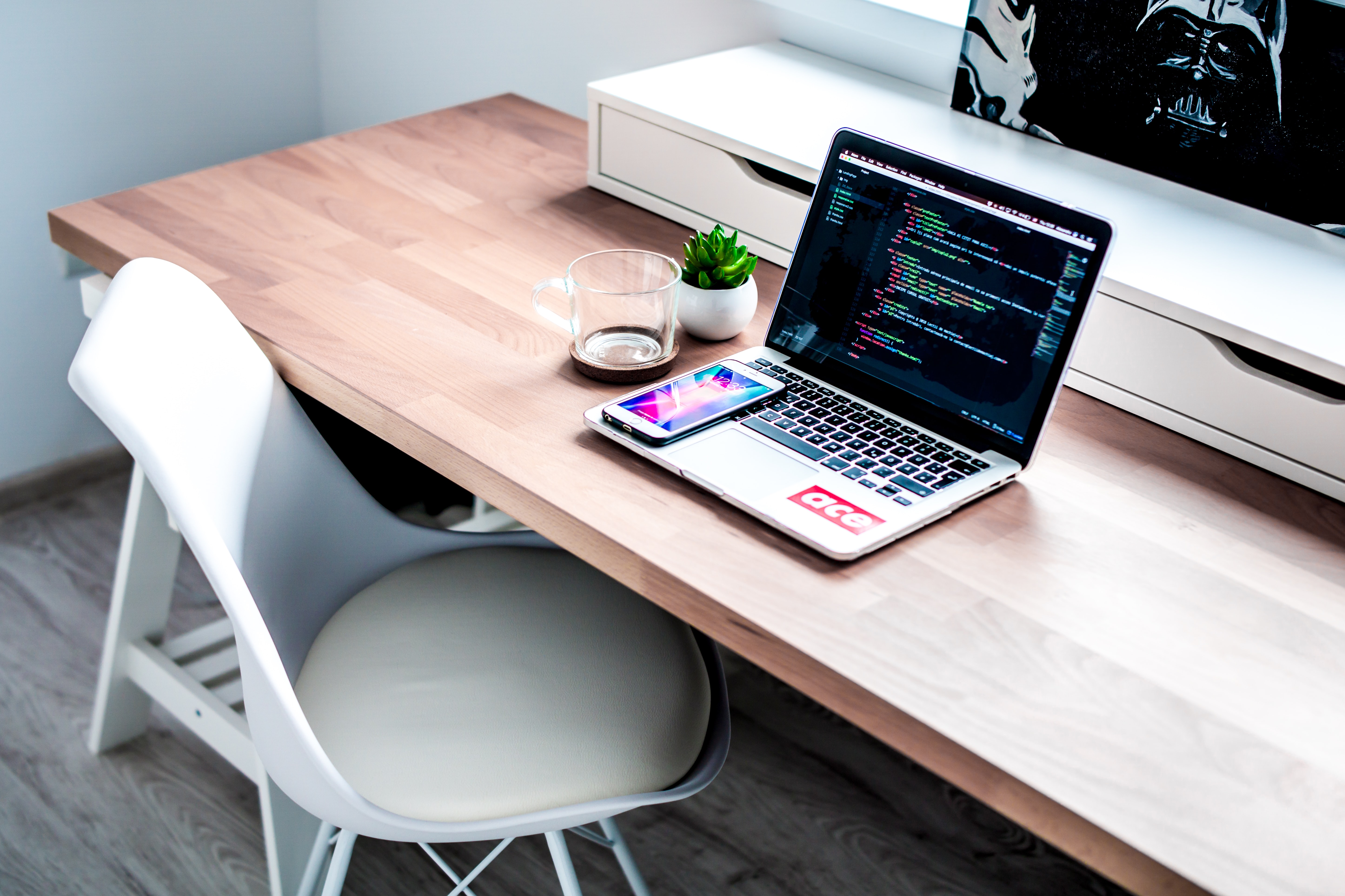 A desk with a laptop showing a coding environment